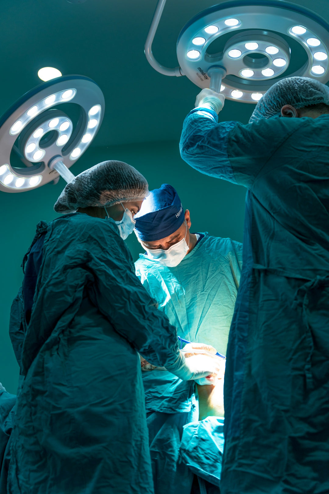 Surgical team operating in a sterile theatre — the clinical-grade environment TROTEC TAC is built for