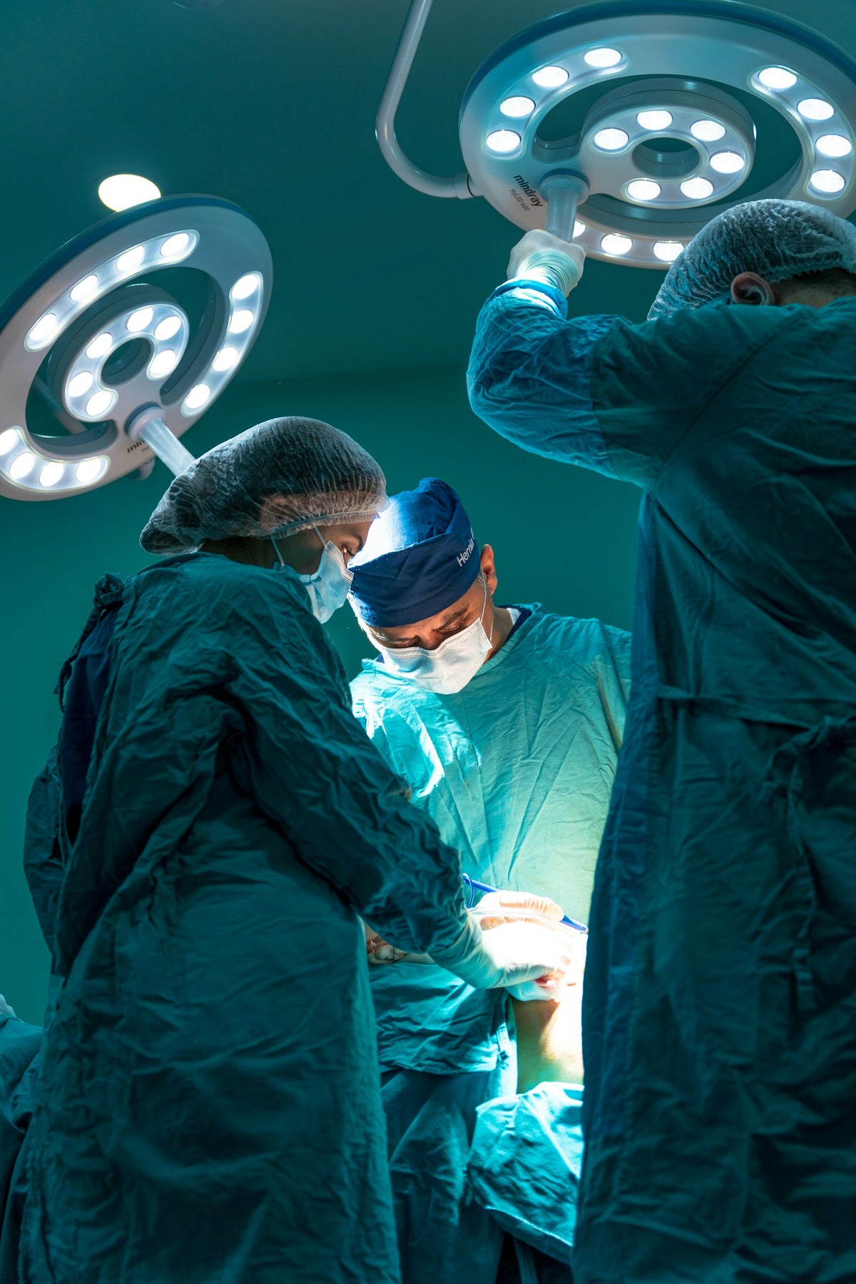 Surgical team operating in a sterile theatre — the clinical-grade environment TROTEC TAC is built for